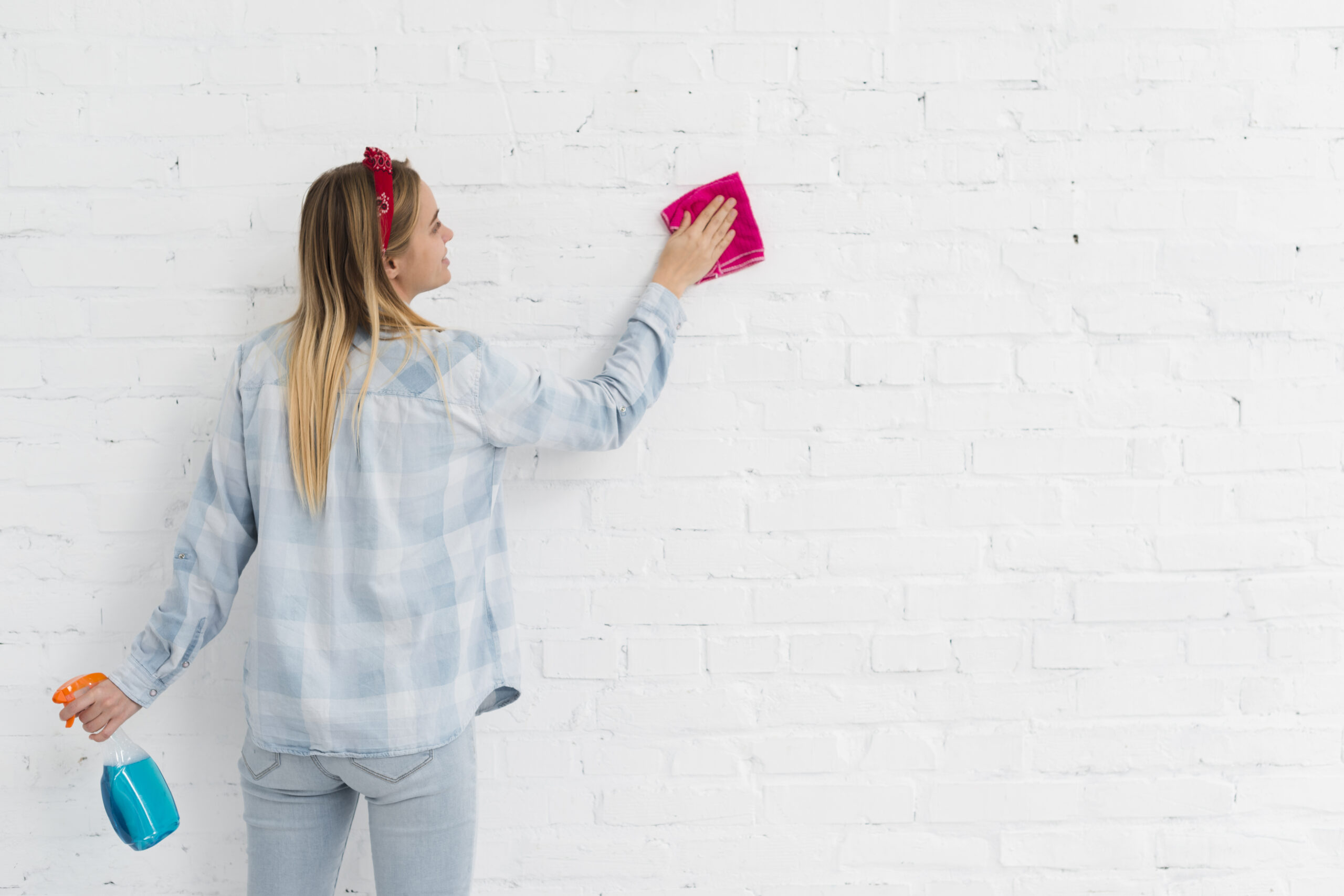 front view woman cleaning wall